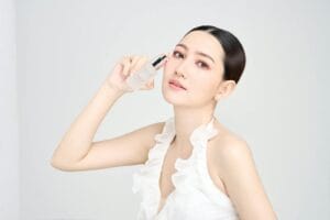 Serene model holding skincare product in modern beauty photoshoot. skincare overclaim.
