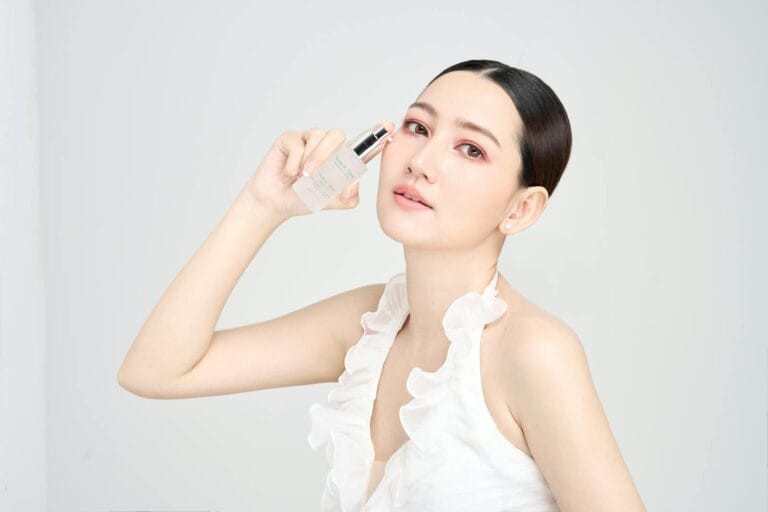 Serene model holding skincare product in modern beauty photoshoot. skincare overclaim.