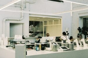 A group of people standing around a kitchen kosmetik