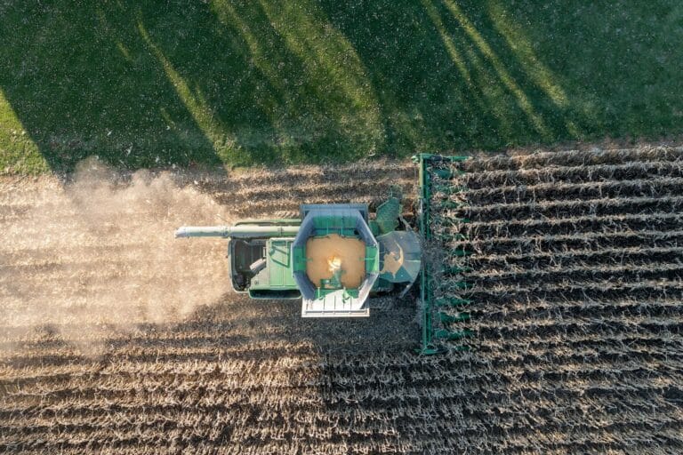 Drone shot of a combine harvester in a cornfield during harvest in Theilman, MN.
