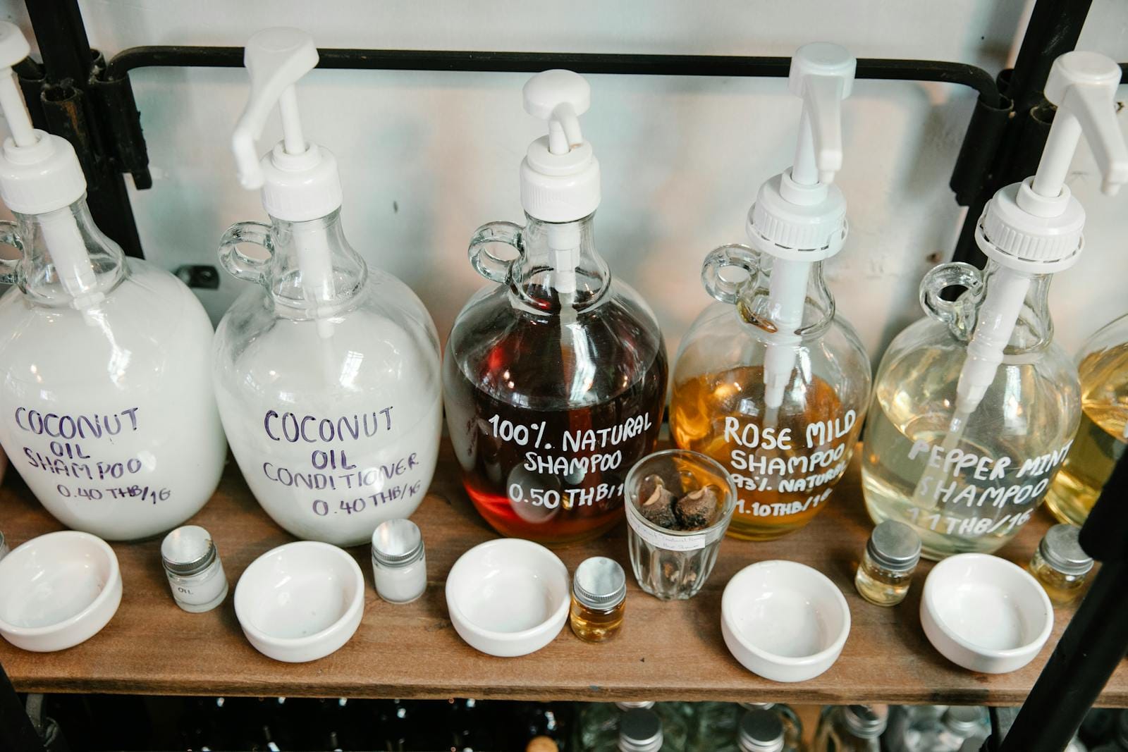 Eco-friendly shampoos and conditioners on a shelf, showcasing natural and coconut oil products.