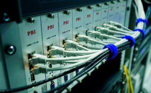 Close-up of ethernet cables connected to a network switch panel in a data center.