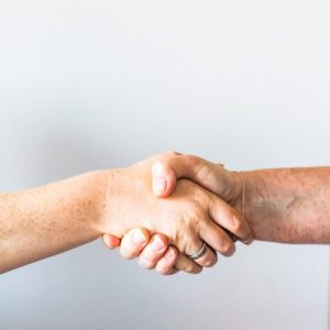 Photo by Sincerely Media person holding hands of another person